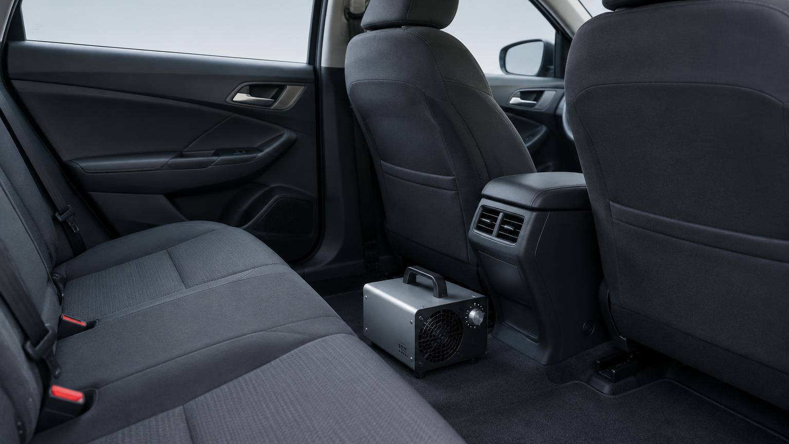 Ozone generator placed on the floor of an empty car cabin for odour treatment