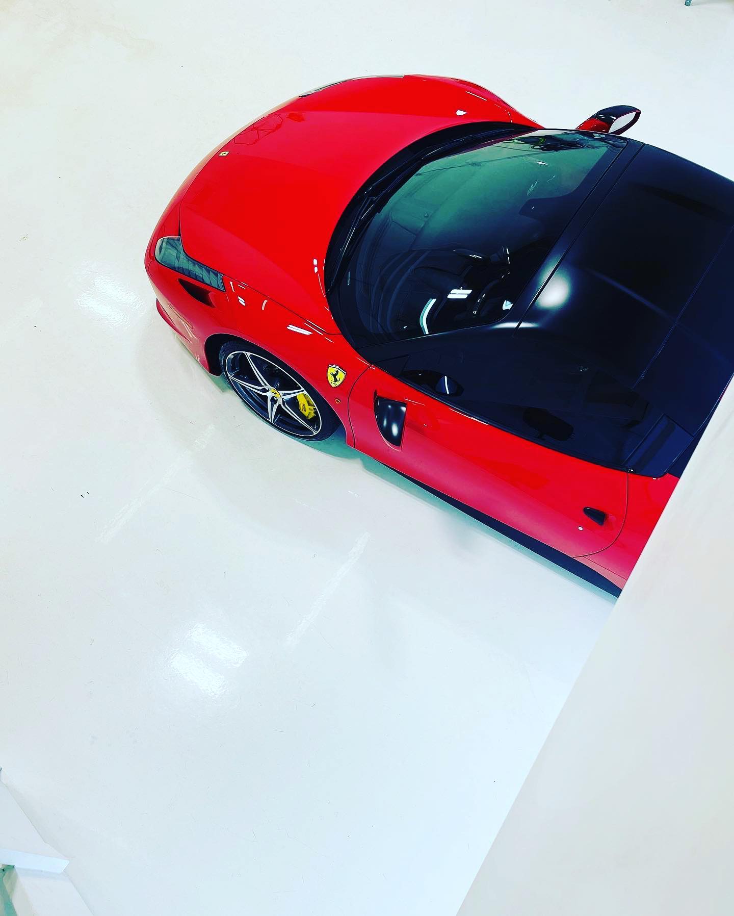 Ferrari 488 after ceramic coating, sharp panel reflections showing corrected clear coat