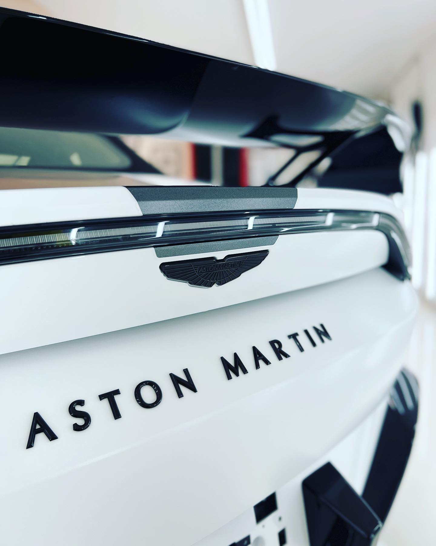 Pearl white Aston Martin rear badging, kept monthly under AVOTTO Caretaker